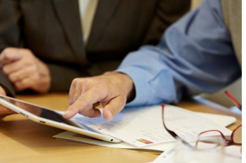 Financial Advisor showing client information on a tablet